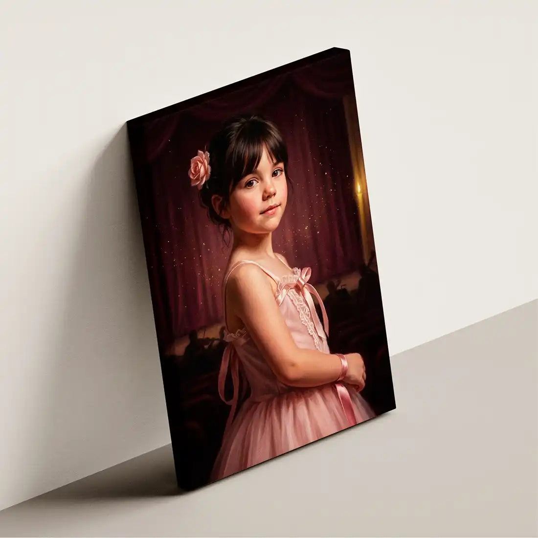 A vertical canvas wall art print leaning against a light gray wall. The print features a portrait of a young girl with dark hair and a pink flower accessory, wearing a pink dress in front of a dark red curtain.