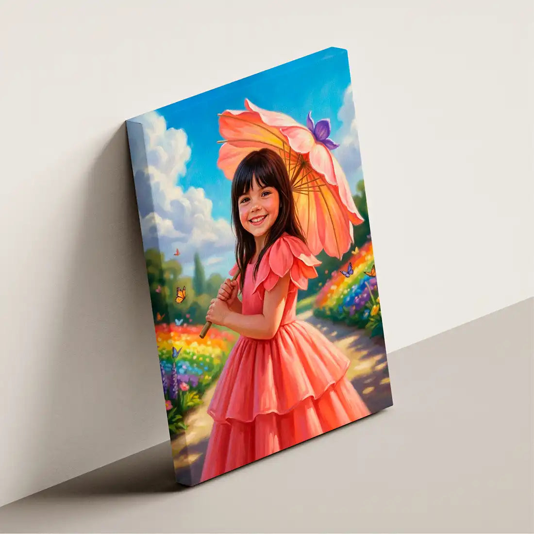 A vertical canvas wall art print leaning against a light gray wall. The artwork depicts a young girl with dark hair smiling and holding a large pink flower-shaped umbrella in a colorful garden under a bright blue sky with white clouds.