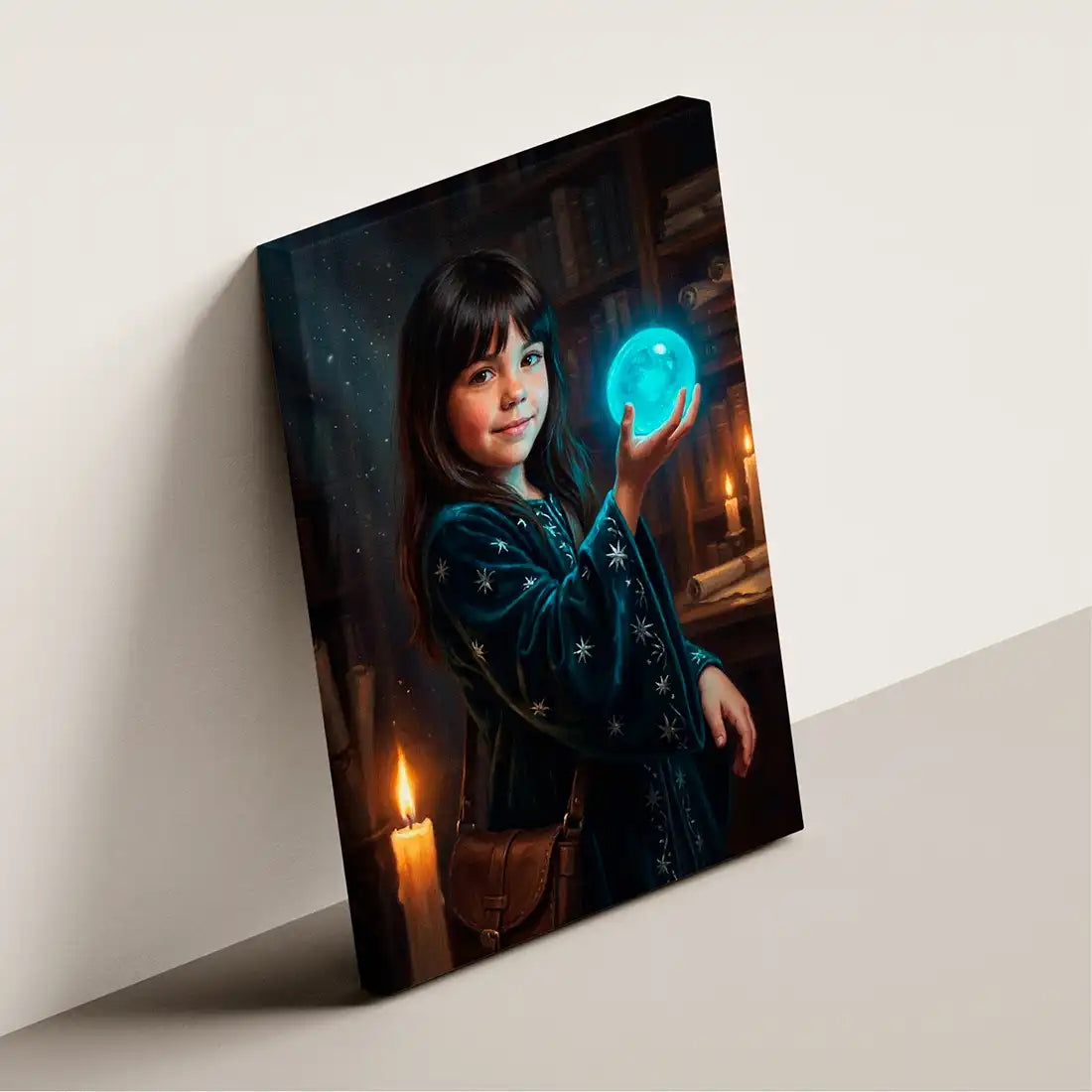 A vertical canvas wall art print leaning against a light beige wall. The artwork depicts a young girl with dark hair holding a glowing blue orb, wearing a dark blue robe with white star-like patterns, in a dimly lit room with candles and bookshelves.