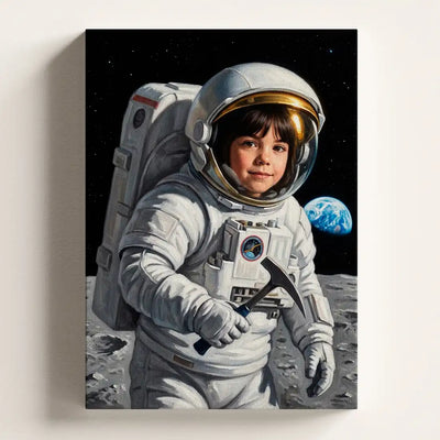 A vertical canvas wall art print depicting a child dressed as an astronaut standing on a gray lunar surface with a small blue planet in the starry black space background. The canvas is shown hanging against a light beige wall.
